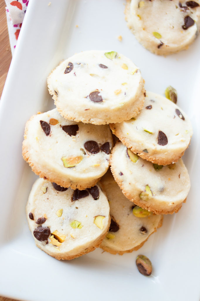 These Lemon Pistachio Shortbread Cookies will melt in your mouth and be the hit of any party! Perfect for wedding showers or baby showers, they really add a touch of class! Shortbread cookies recipe, butter cookies recipe, pistachio cookies recipe, lemon cookies recipe