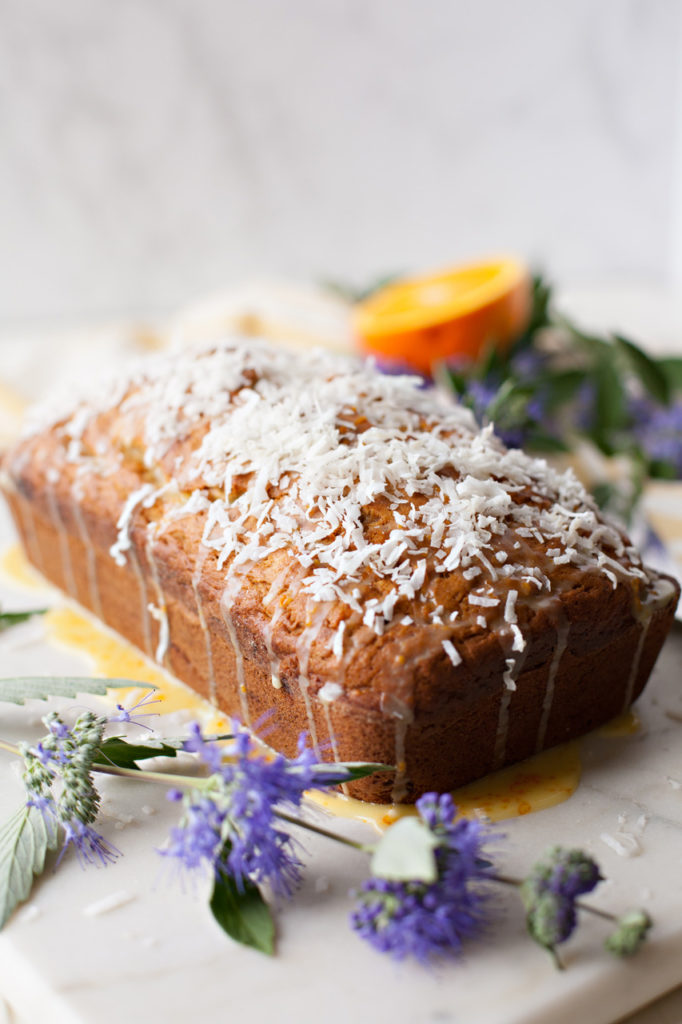 Banana Coconut Bread with Orange Glaze is moist, sweet, tender, and full of flavor! Perfect for any springtime menu!