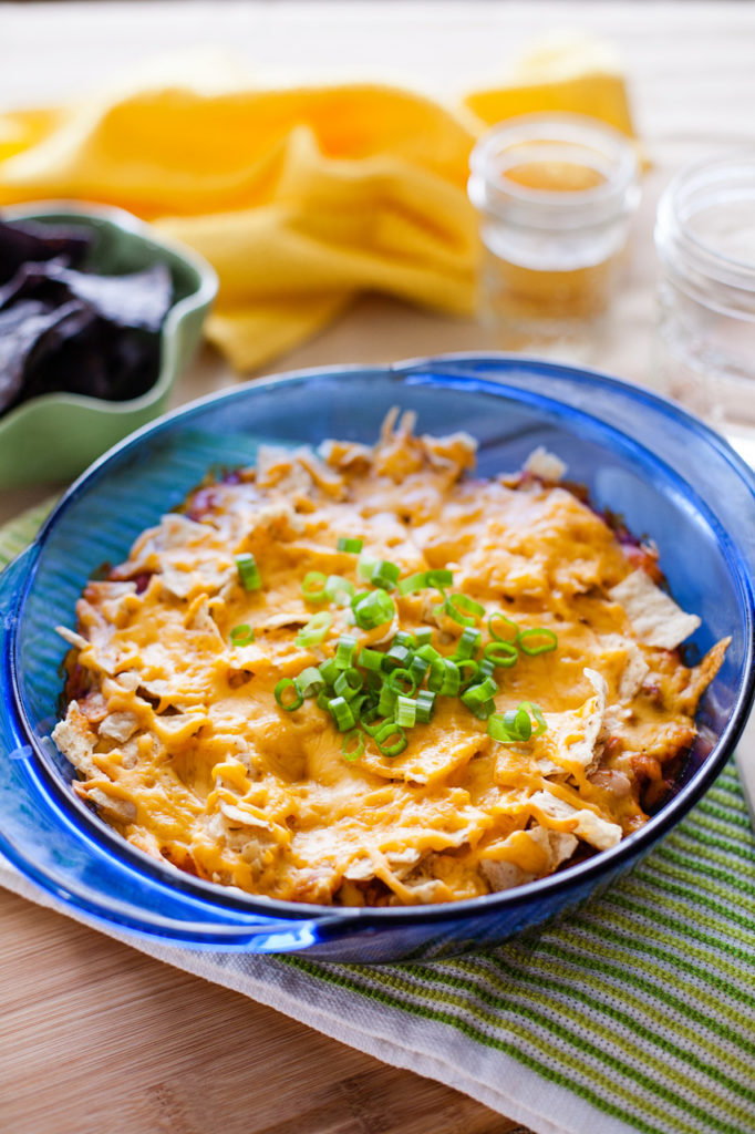 Mix up and bake this family-pleasing Mexican Casserole in just over thirty minutes! Full of tasty meat and beans, and topped with chips and cheese, it's perfect for any night of the week!