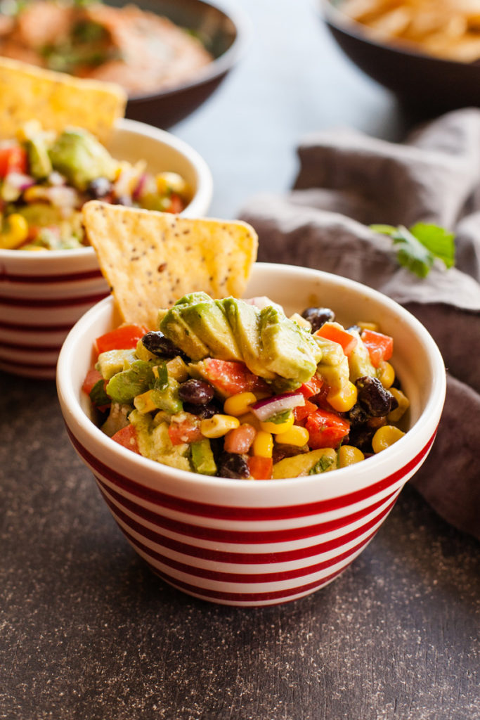 Easy avocado salsa with avocados, tomatoes, corn, beans, and a tasty dressing. 