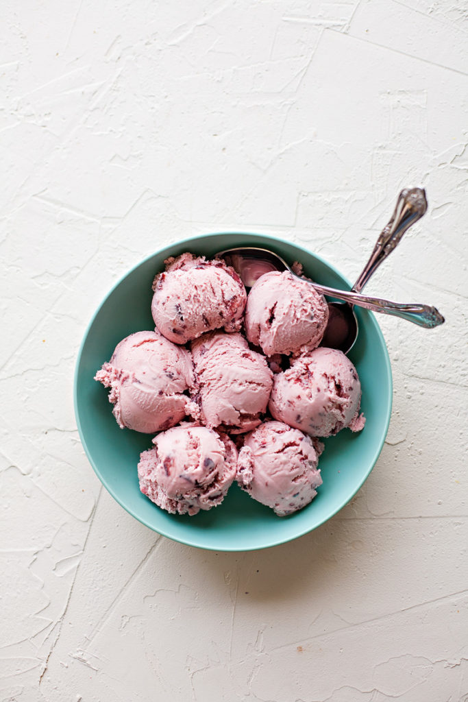 Black Cherry Ice Cream in a bowl with two spoons.