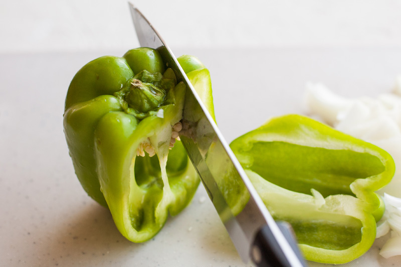 Slicing a green pepper.