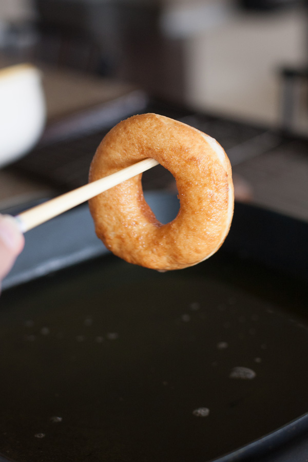 Oil dripping off fried donut.