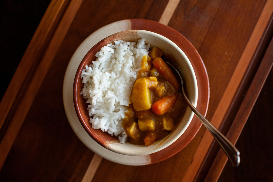 Japanese curry with potatoes, carrots, and chicken.
