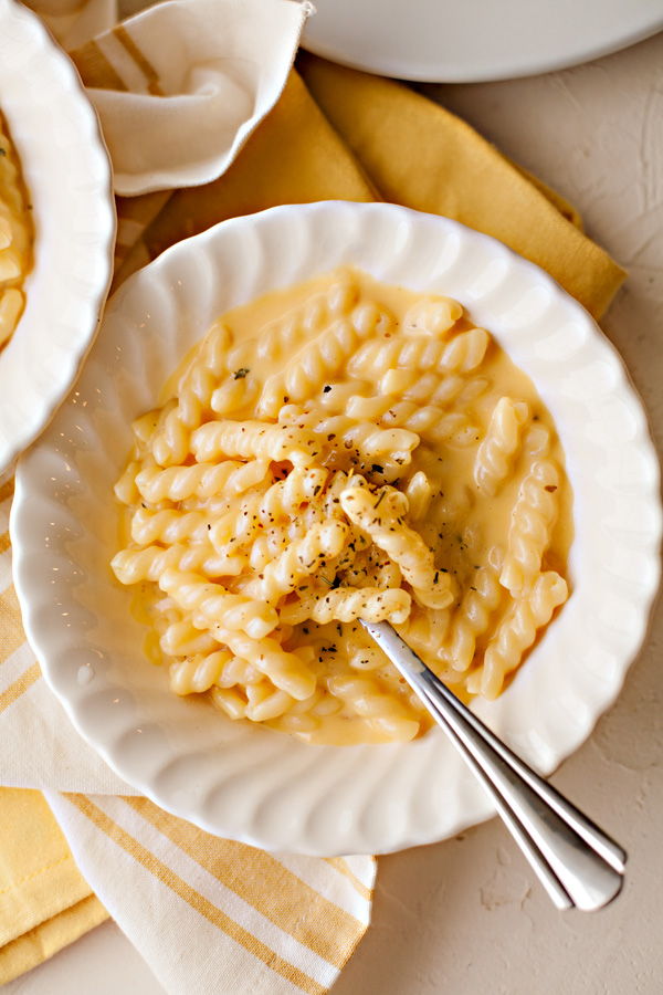Homemade creamy macaroni and cheese in a bowl with a spoon